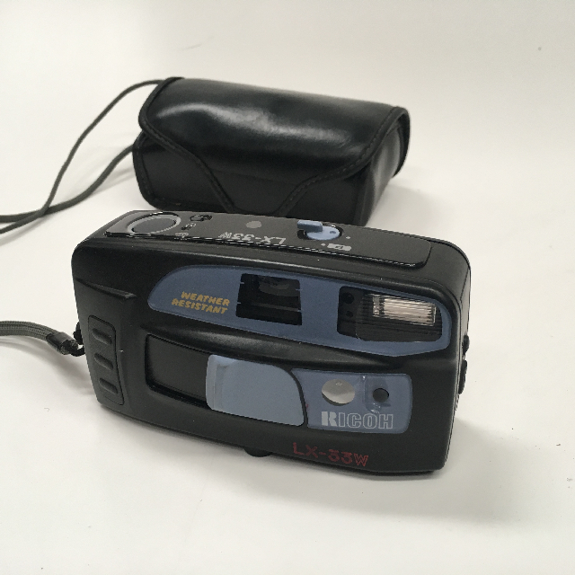 CAMERA, Pocket Camera - Black & Grey Ricoh or CAM0013 - CAMERA, Pocket Camera - Black Grey Ricoh (in Case)